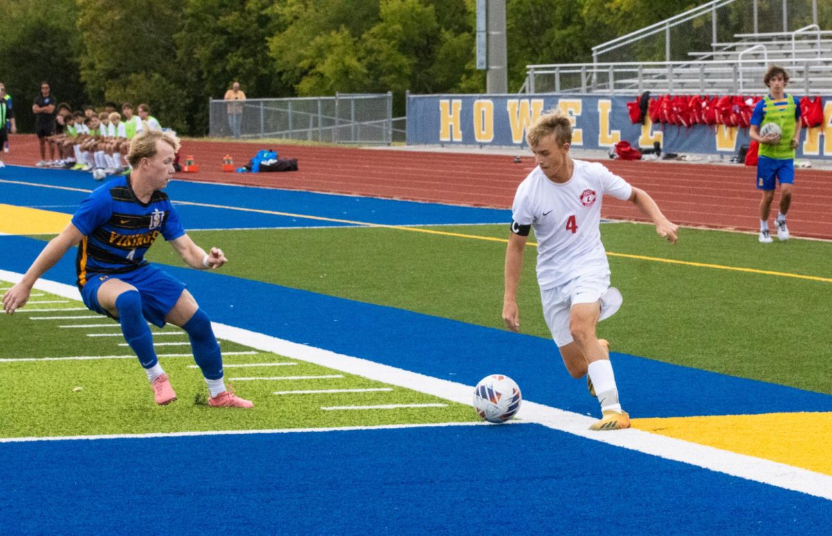 Dylan Handlan (12) moves around the defender and gets ready to cross the ball in. 