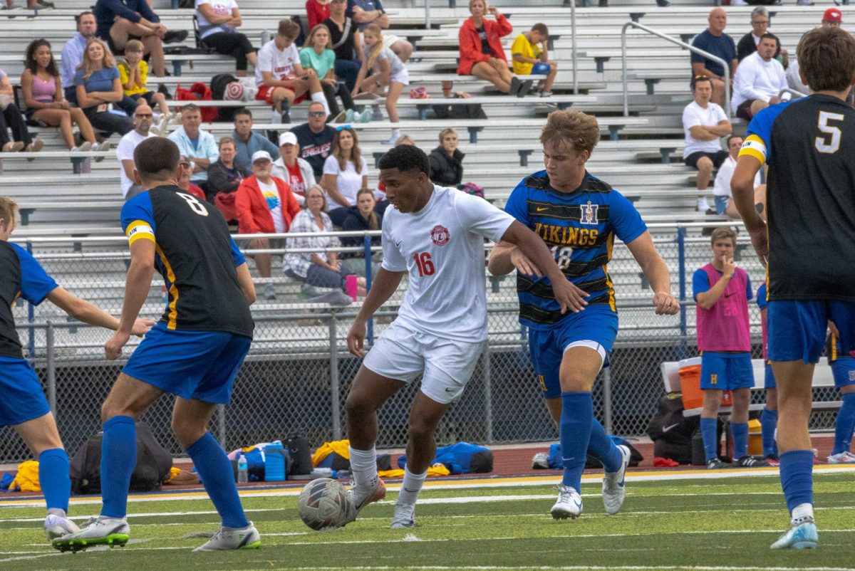 Corey Lynch (11) quickly evades the defenders just before rocketing the ball towards the goal.