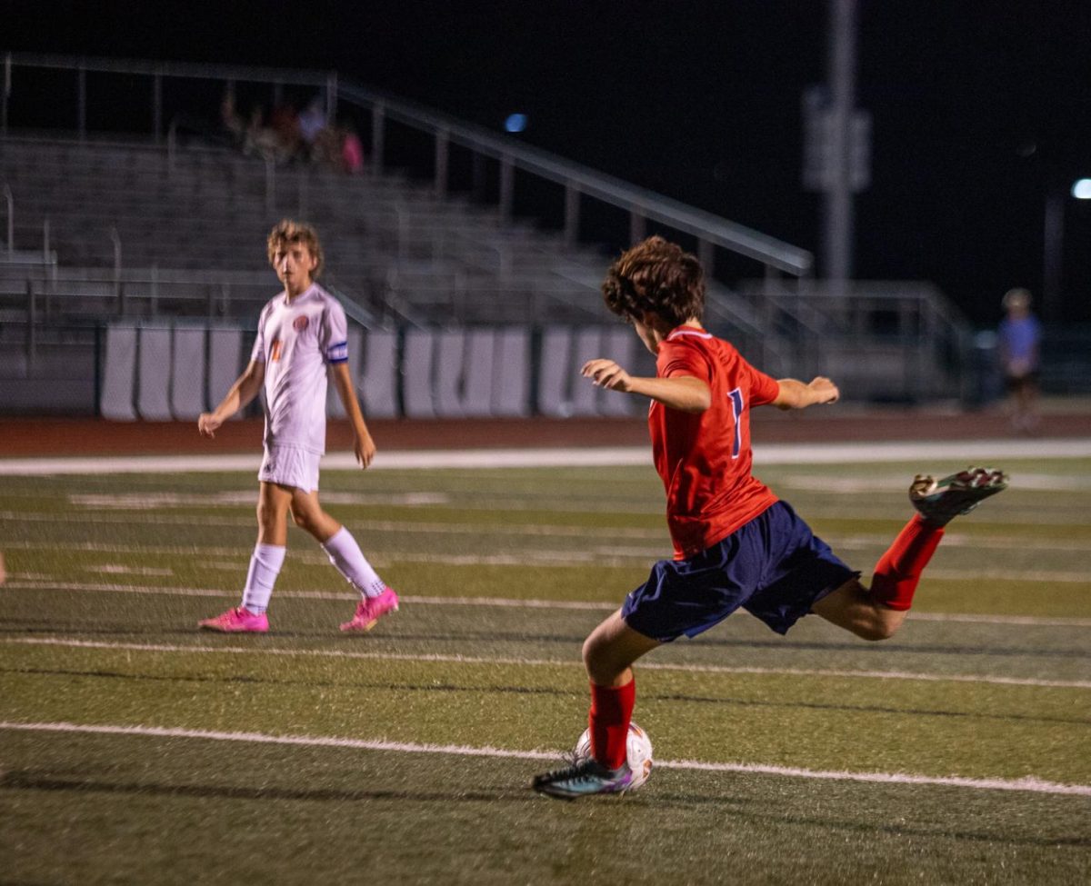 Kaelen Homar (9) takes shot on goal against North Point's goalie.