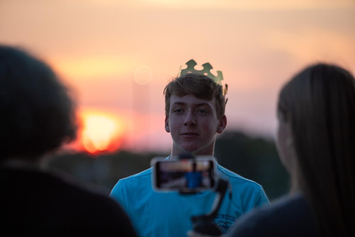 Owen Witte is shown being interviewed by publications reporters.