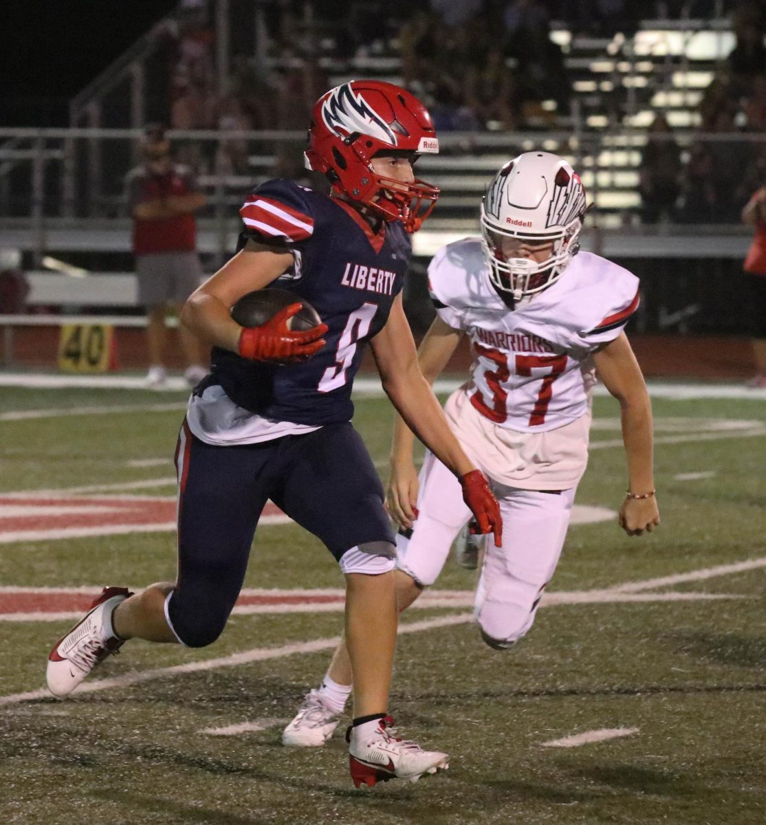 James Alexander (11) runs the ball in a JV football game against Winfield. 