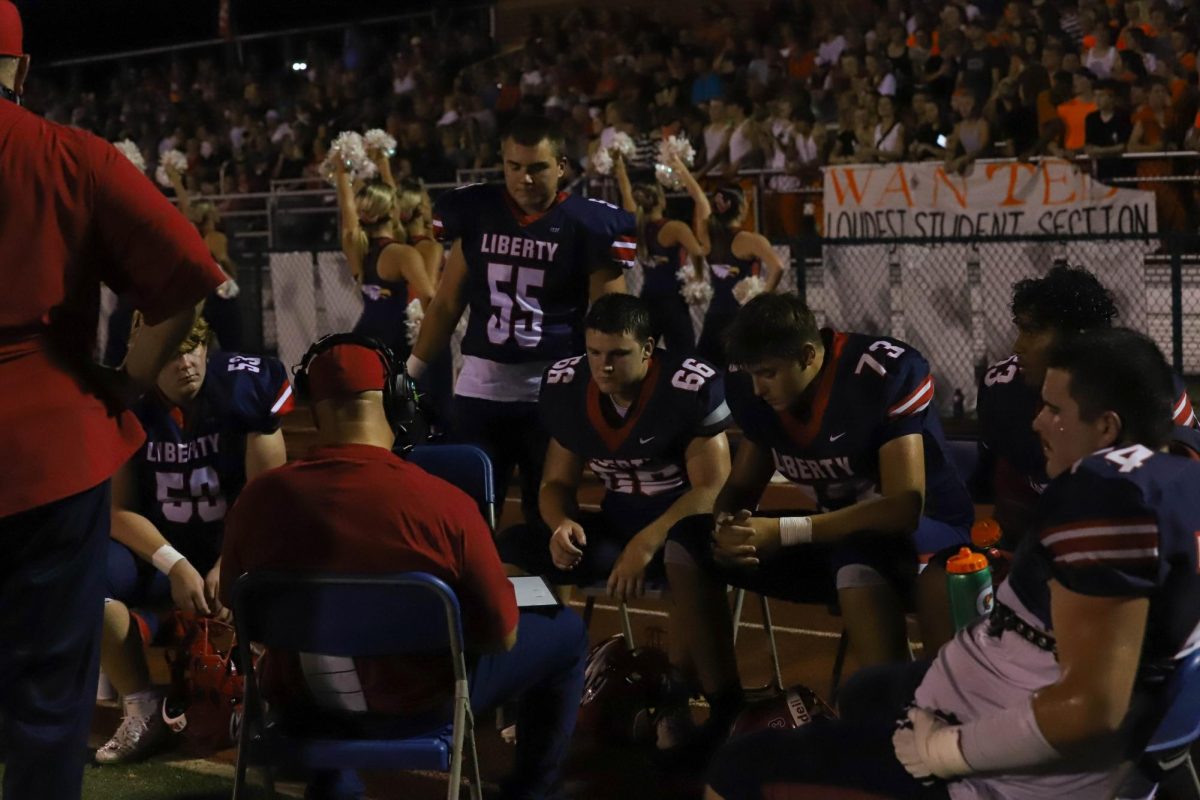 Coach McMillen goes over a play with the linemen during a break. 