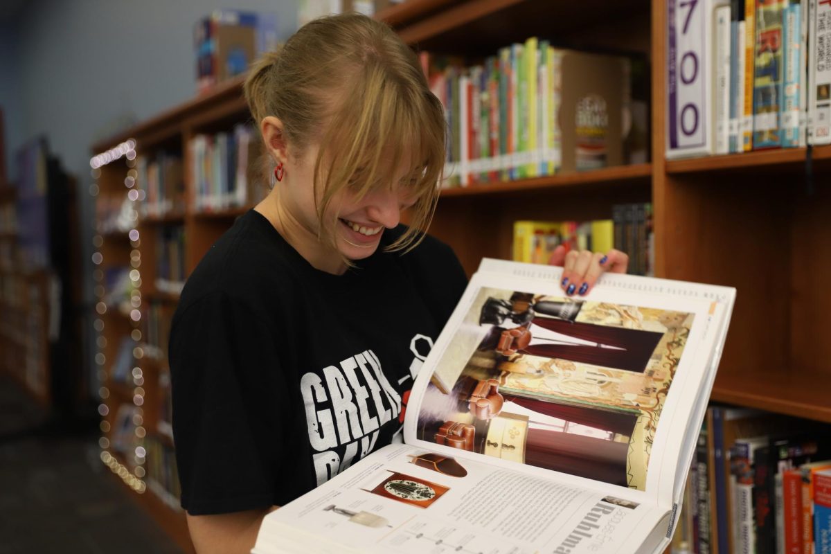 Leah Dudley (11) reads a book that was marketed to her by Book2Brand club.