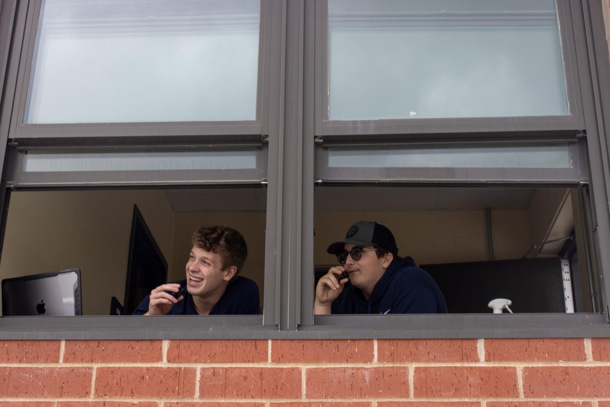 Mason Molitor (11) and Wesley Bartlow (10) call the football game for the publications livestream. 