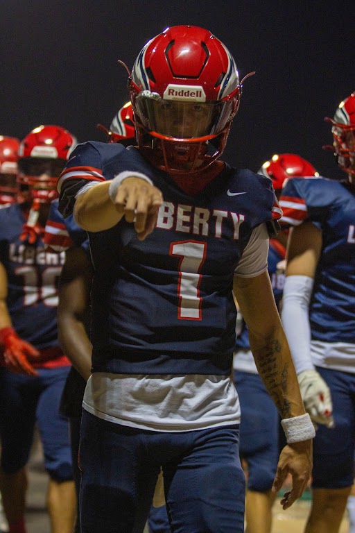 Cody McMullen (12) points as the team walks off the field for halftime. After trailing 14-0, the Eagles rallied to tie the game, 20-20 at the end of the first half.  