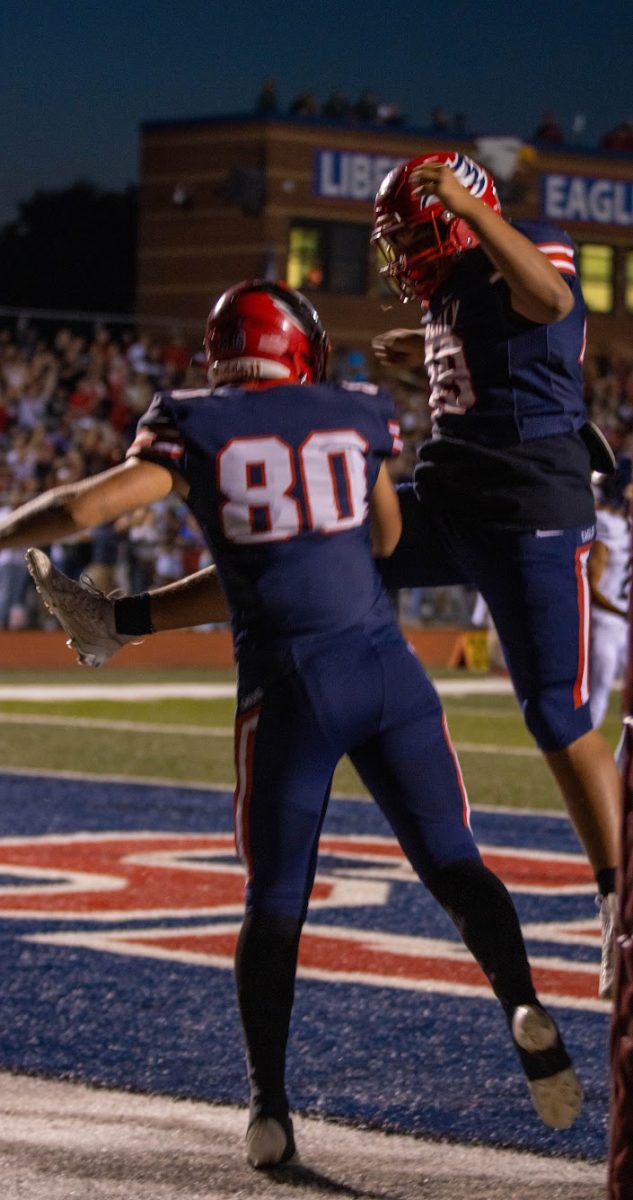 Jonah Kaler (10) celebrates a touchdown with teammate. 