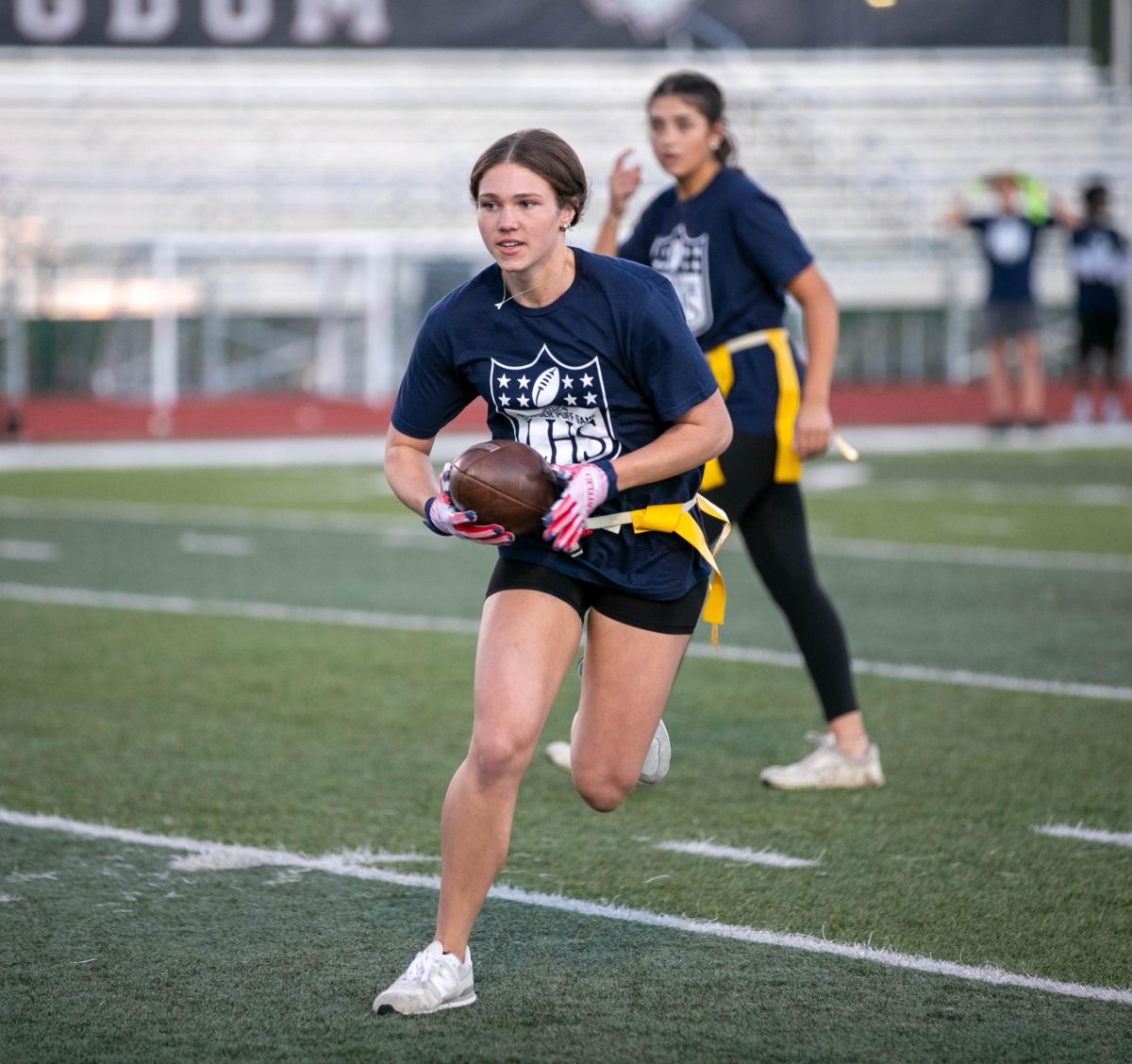 Anisley Kammermeyer runs with the ball after quarterback hands it to her during annual powderpuff game on Oct. 2.