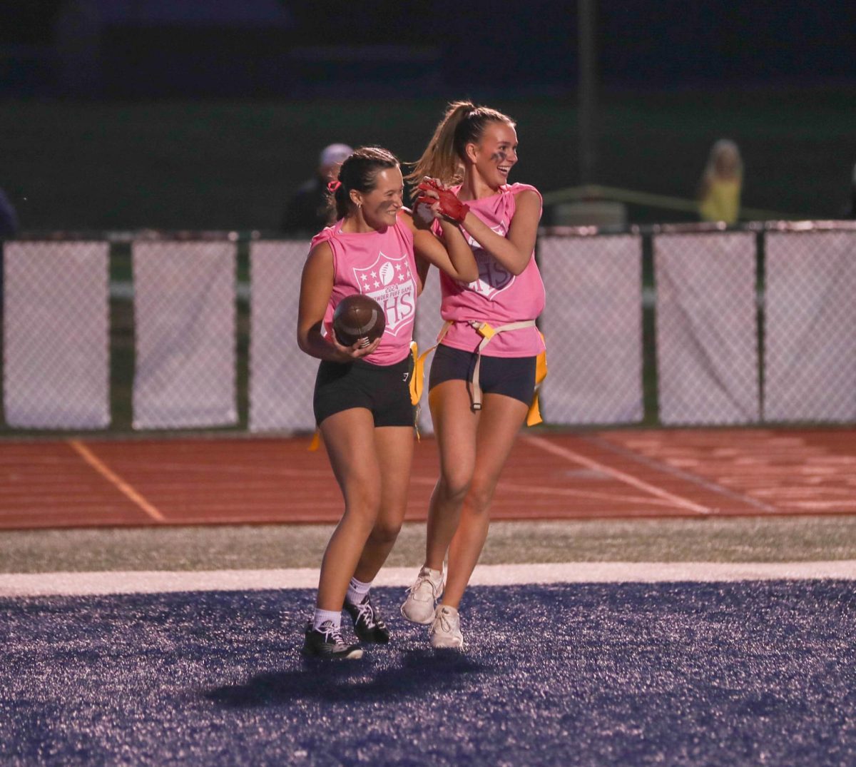 Payton Hemmer (left) and Emily May (right) high five after Hemmer's touchdown during the annual powderpuff game on Oct. 2.