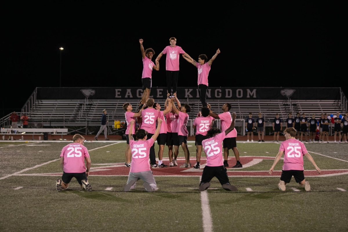 Senior cheerleaders get in a pyramid for their performance during the annual powderpuff game on Oct. 2.