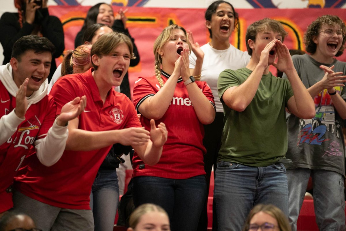 Multiple seniors cheer to win grade level cheering competition at the homecoming pep assembly on Oct. 3.