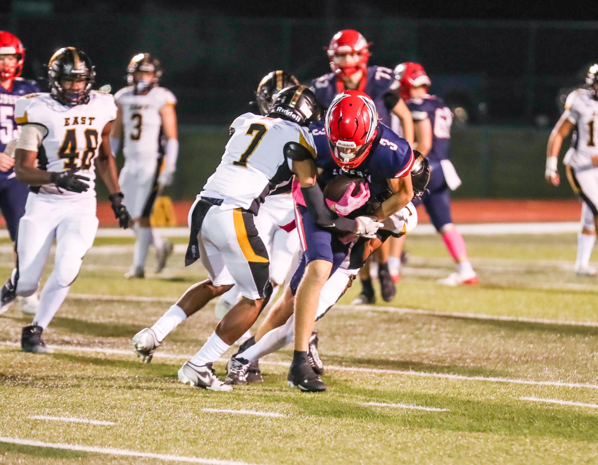 Camden Cooper (11) secures the ball while fighting the lions defense. 