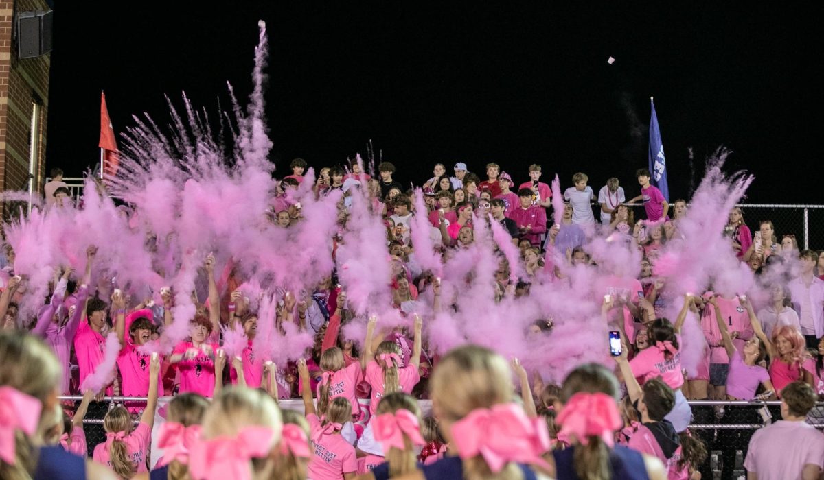 Students toss powder at the annual pink out game in support of breast cancer awareness.