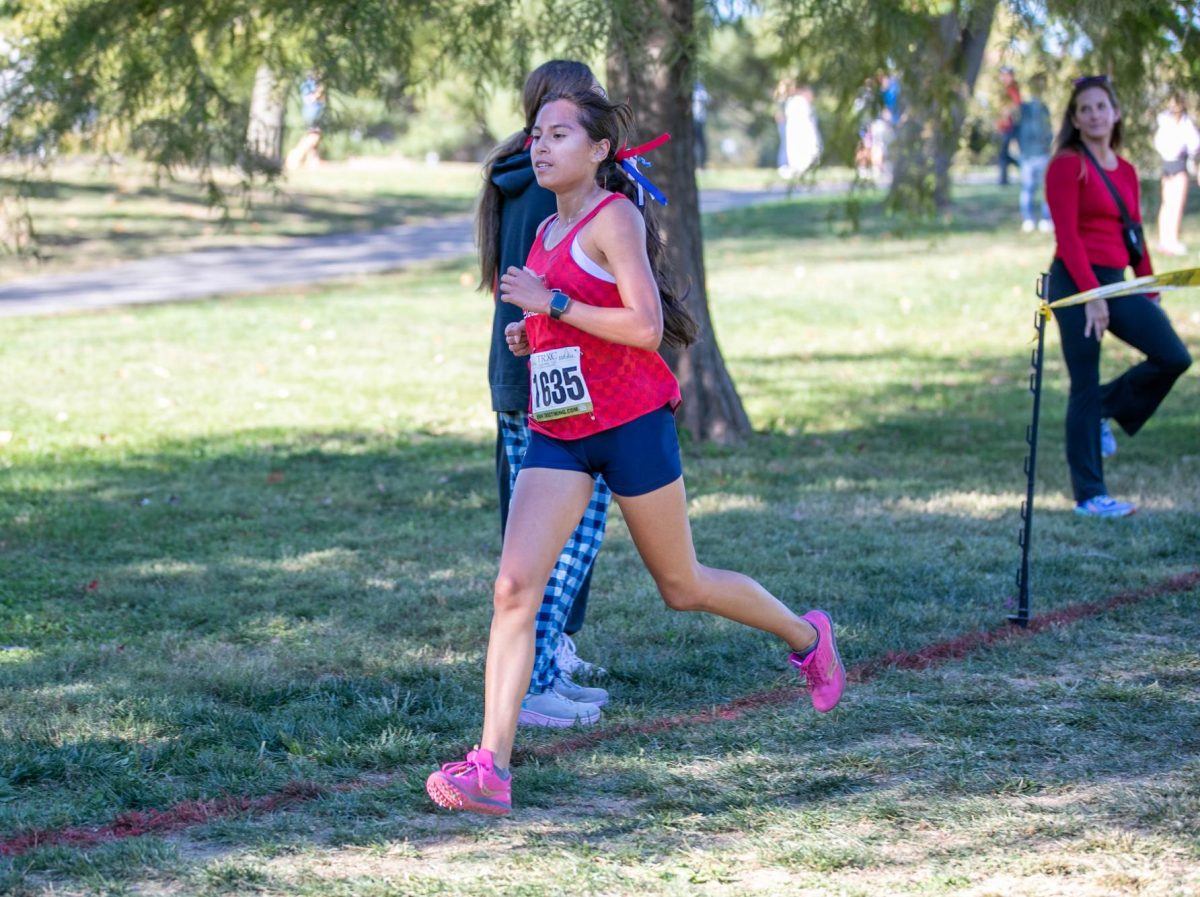 Bella Navarro-Sanchez (10) strides wide on her thirtd lap during her race at the GAC Conference.