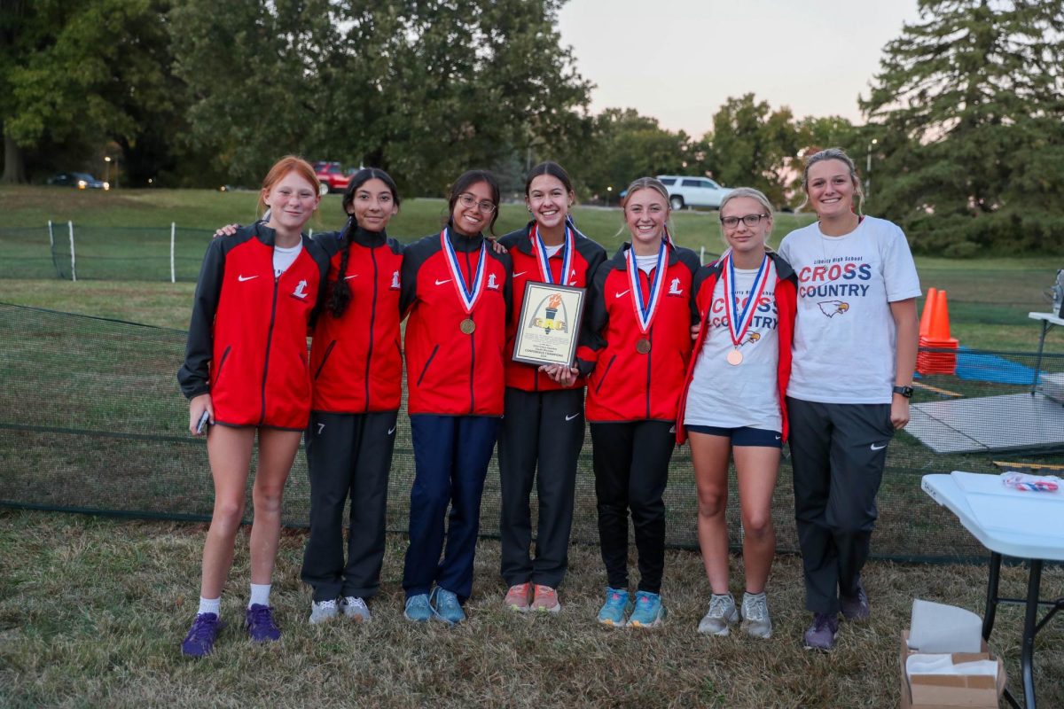 The varsity girls cross country team poses with their plaque after placing first in the GAC Conference meet at McNair Park. 