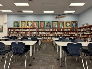 Captivating paintings of famous authors are proudly displayed in the library. 