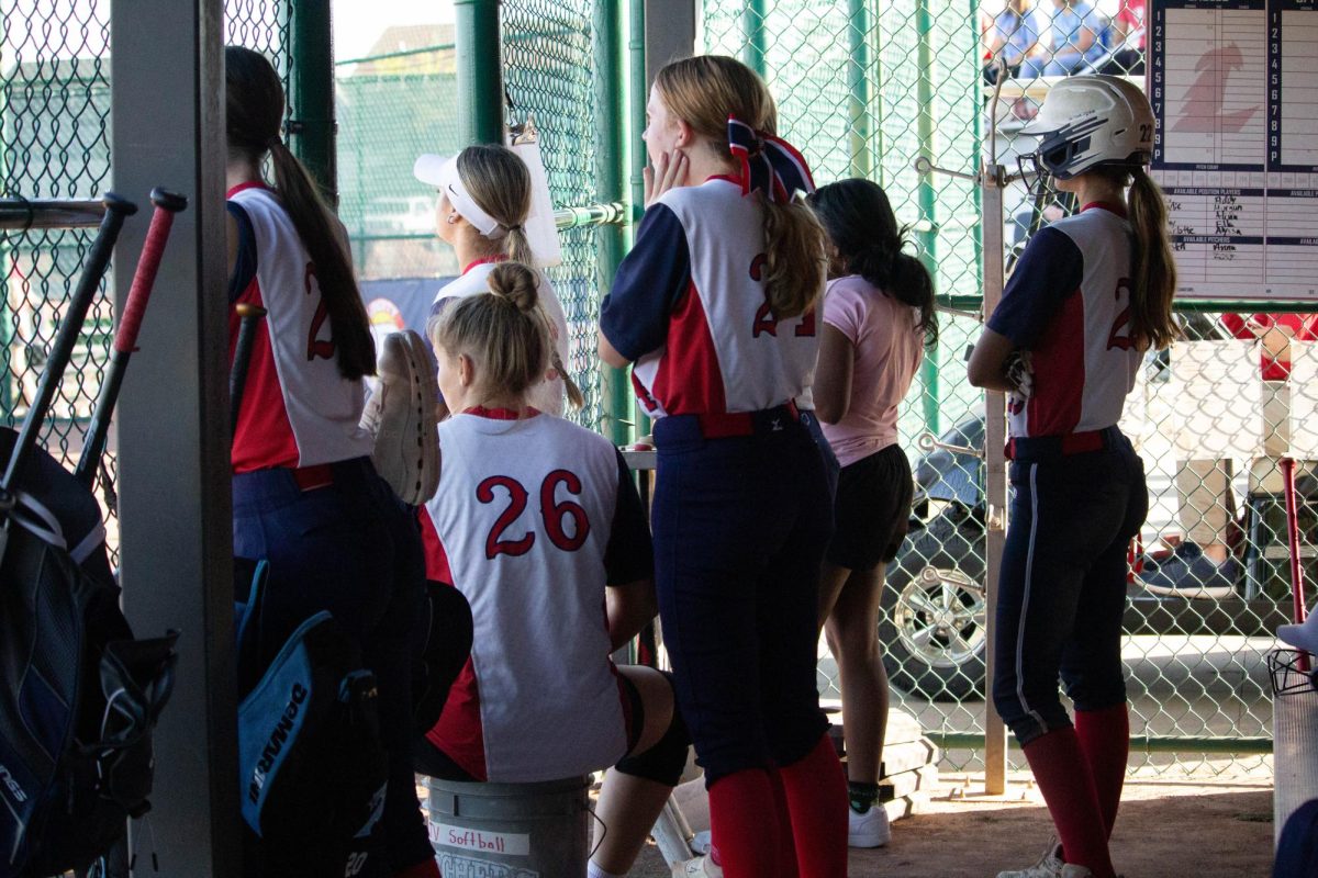 Addison Ehrhard (9) cheers anxiously for her teammate up to bat.