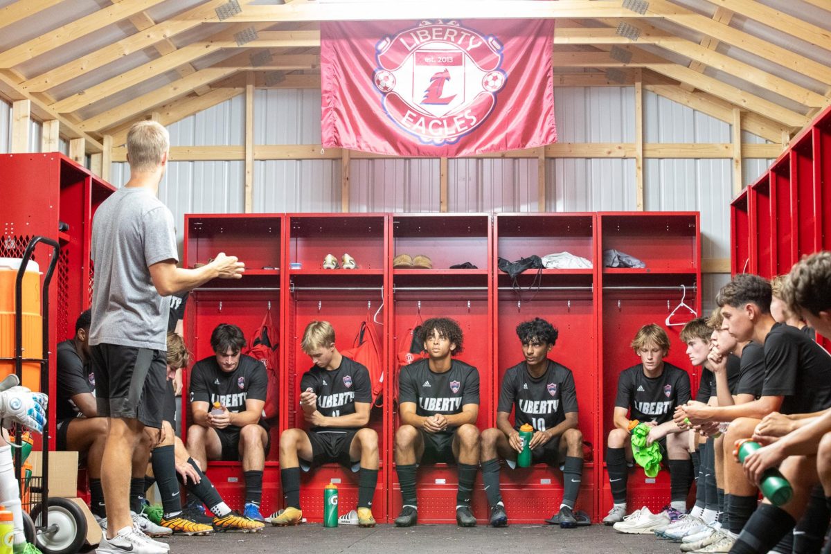 The boys varsity soccer team listen as Coach Luedecke lectures before they played Howell Central.