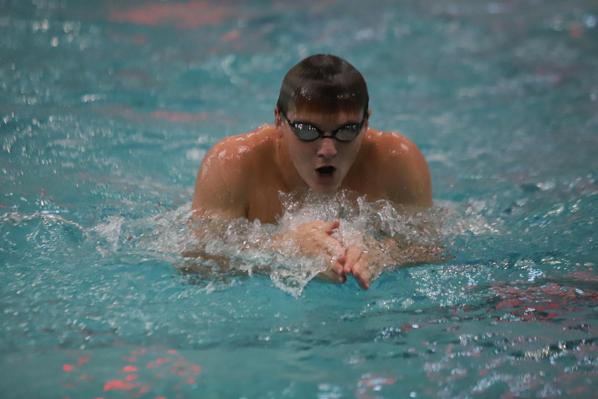 Ryan Lipski (11) breath strokes his way down the pool. 