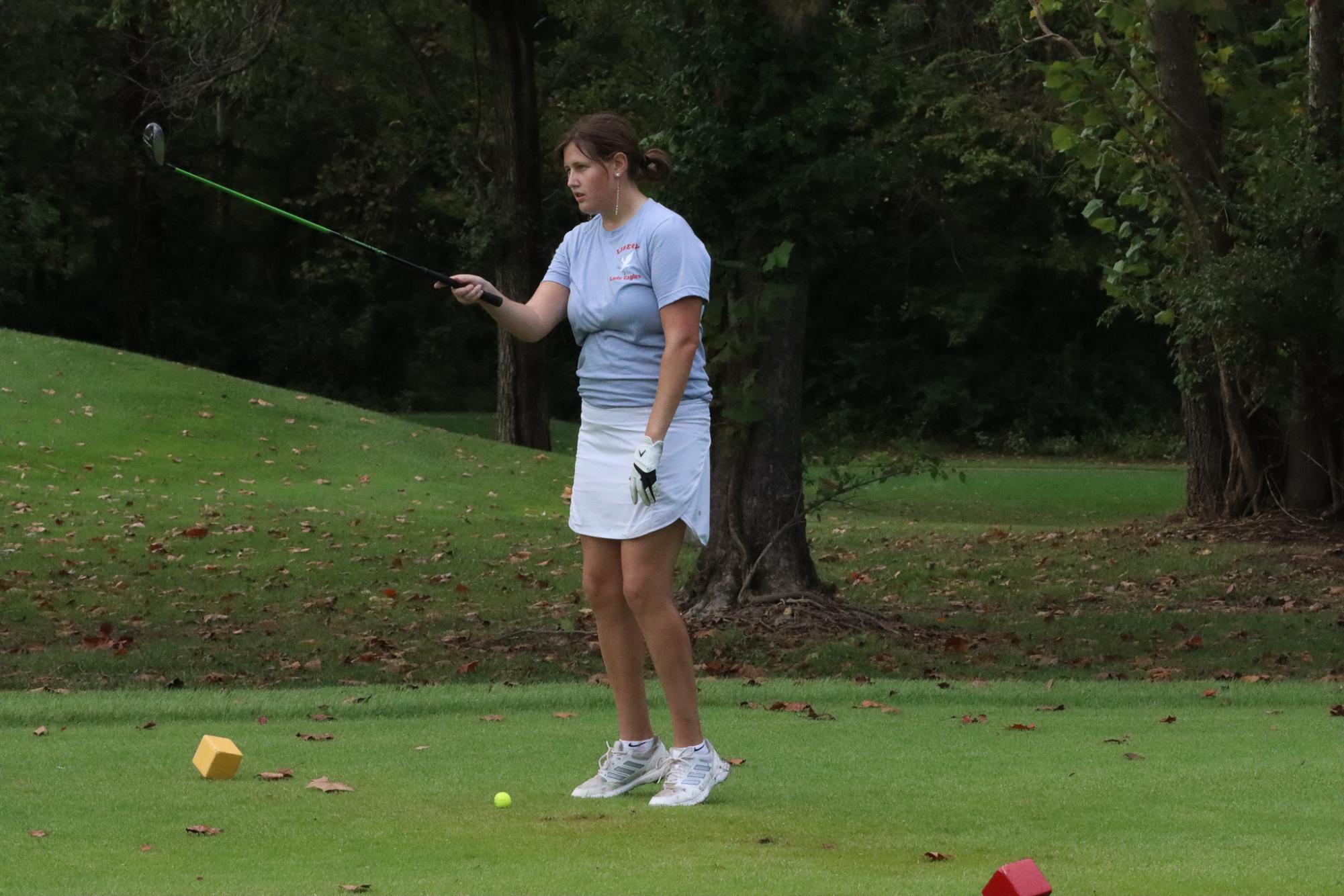 Sophia Heygi (12) lines herself up for her first tee shot on senior night. 