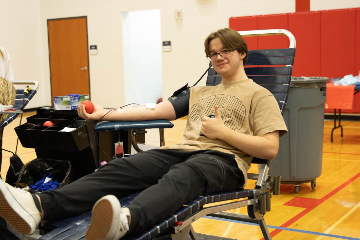 Tyler Bugg (11) poses while having his blood drawn at the fall blood drive.