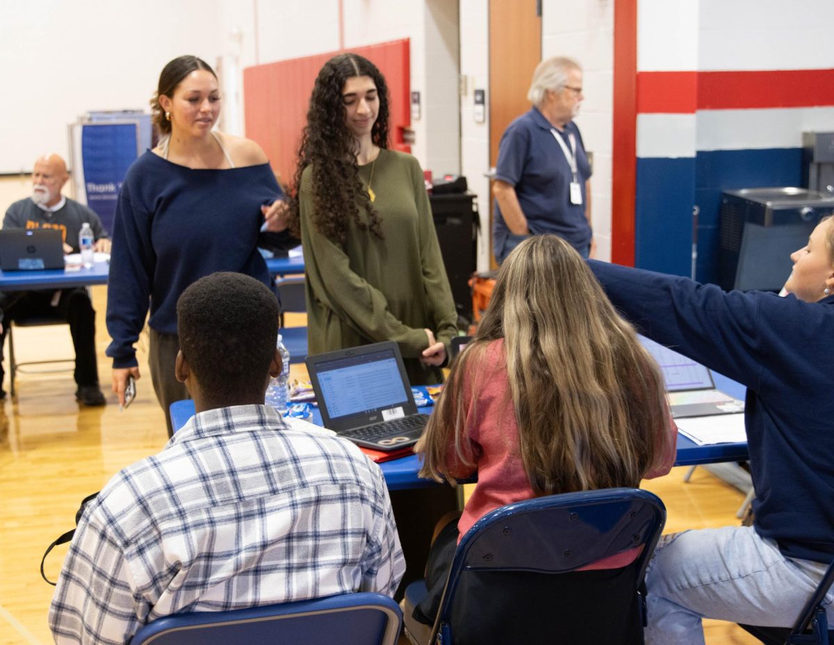 Mariah Levan (12) and Layla Awadallah (12) receive directions about where to go during the blood drive 