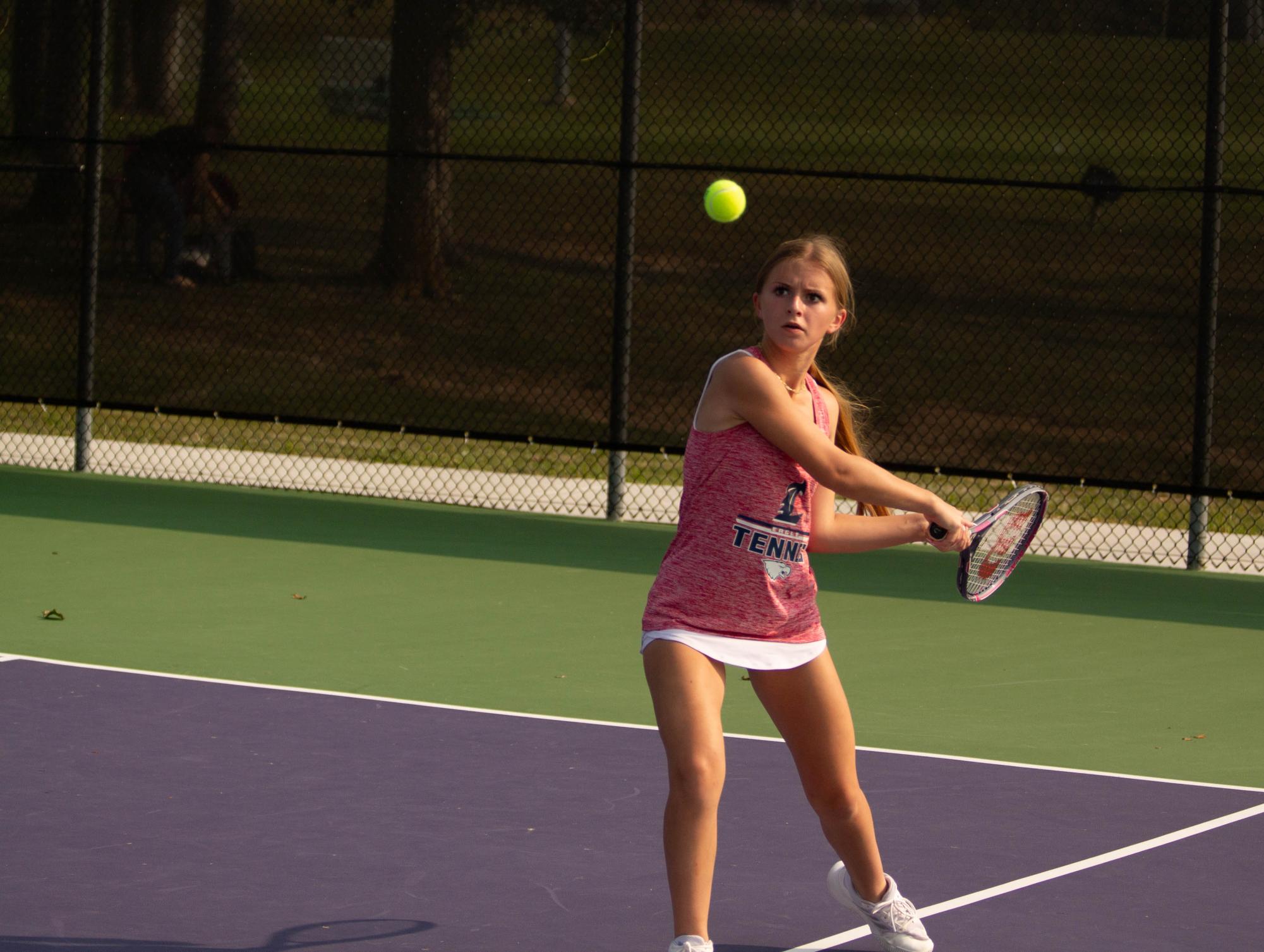 Katelyn Grant (9) returns the ball in her singles match against Troy, 