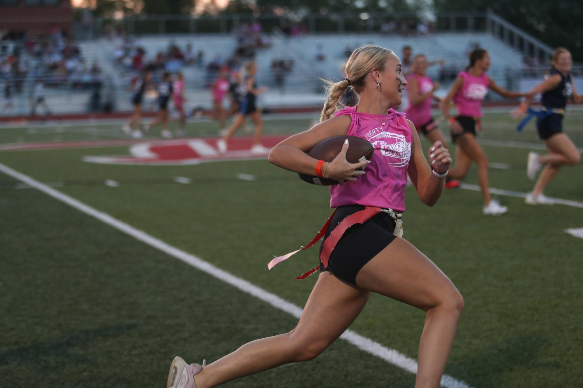 Jenna Handland (12) sprints across the field, during last year's powder puff game. The seniors won the game. 48-46.