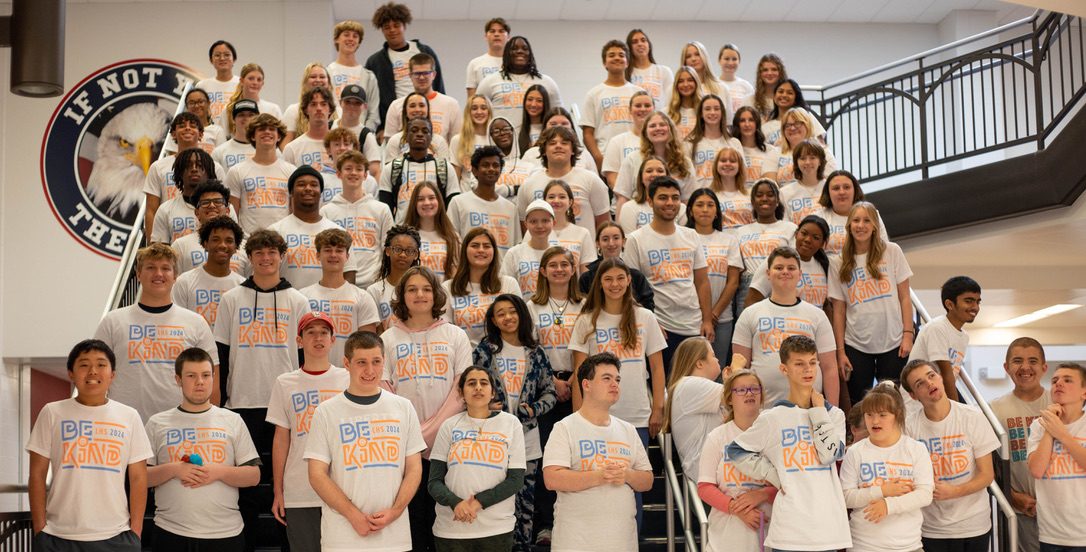 Be Kind shirt recipients pose for a photo on the main stairwell at the end of fourth hour. 