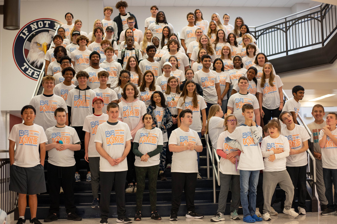 Be Kind shirt recipients pose for a photo on the main stairwell at the end of fourth hour. 