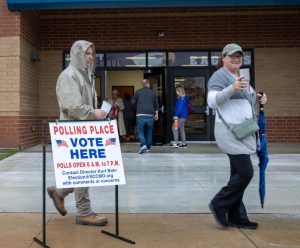 The day of the election was rainy and cold. Several voters brought umbrellas and warm drinks to keep them company while waiting.
