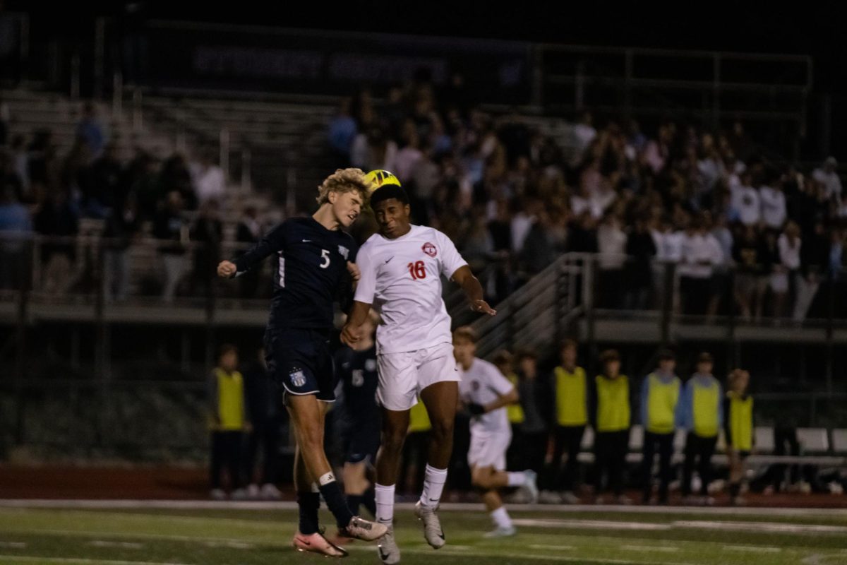 Corey Lynch jumps up or a head ball with the St. Dominic defender.