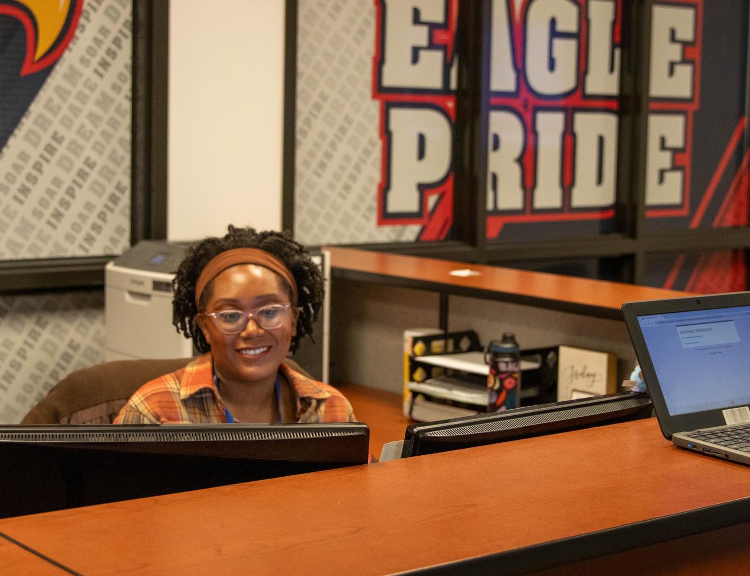 New administrative assistant Erin Gomillion works on her computer at the front desk in the student center.