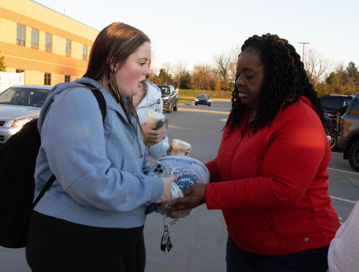 A student donates a turkey to the No Hunger Holiday organization.