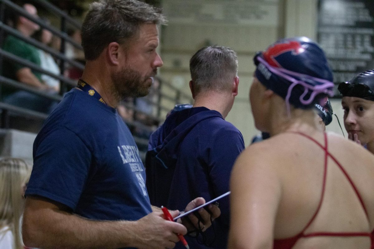 Head Coach Gregory Franklin coaches Violet Grau (middle) and Caitlyn Chandonnet (right).