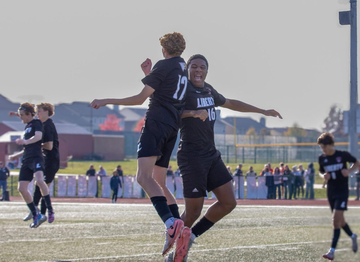 Tyler Meier (11) and Corey Lynch (11) jump up for a shoulder bump to get ready for the game.