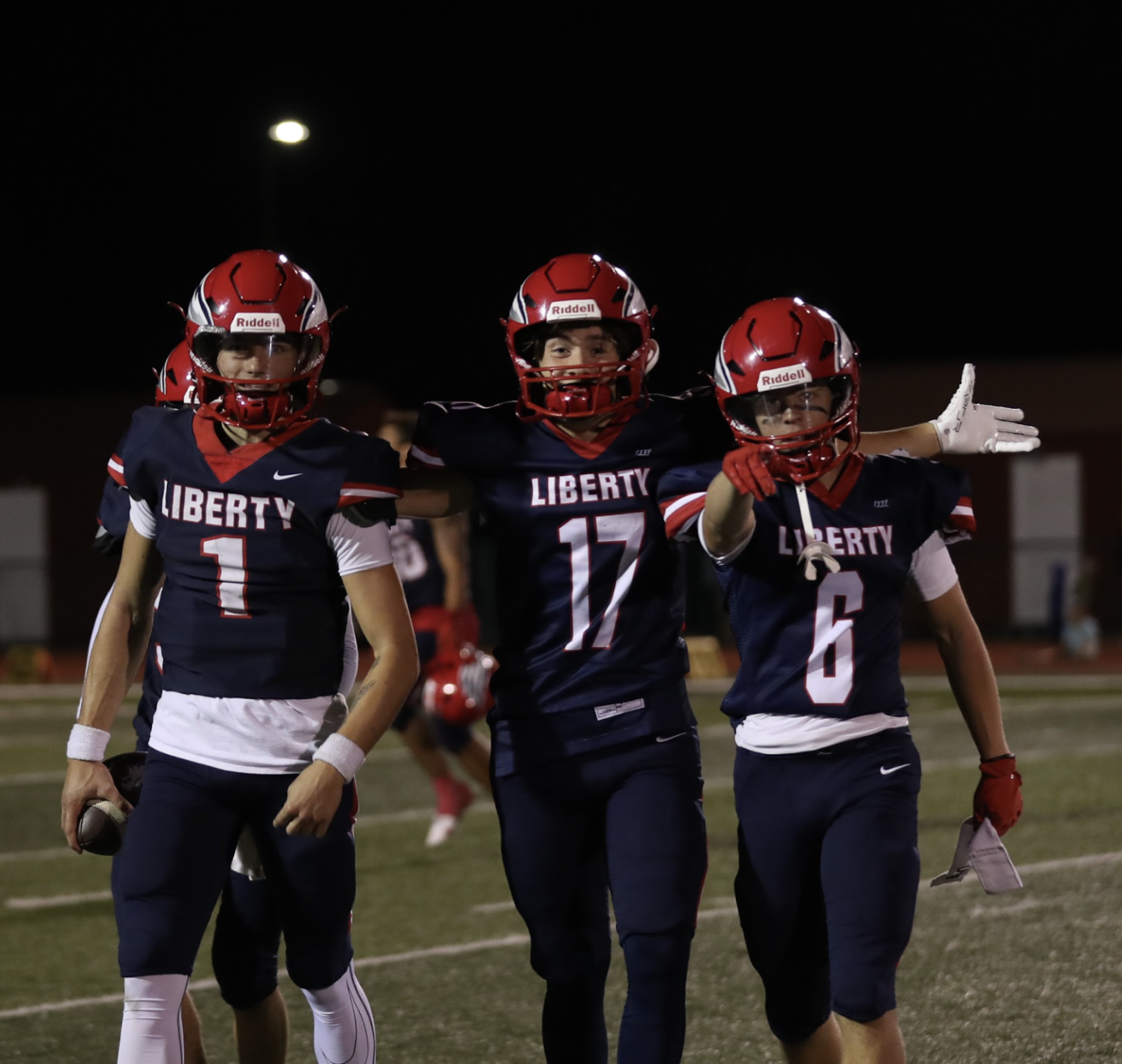 Caleb Orcutt (center) walks off the field with Cody McMullen and Caiden Galati.