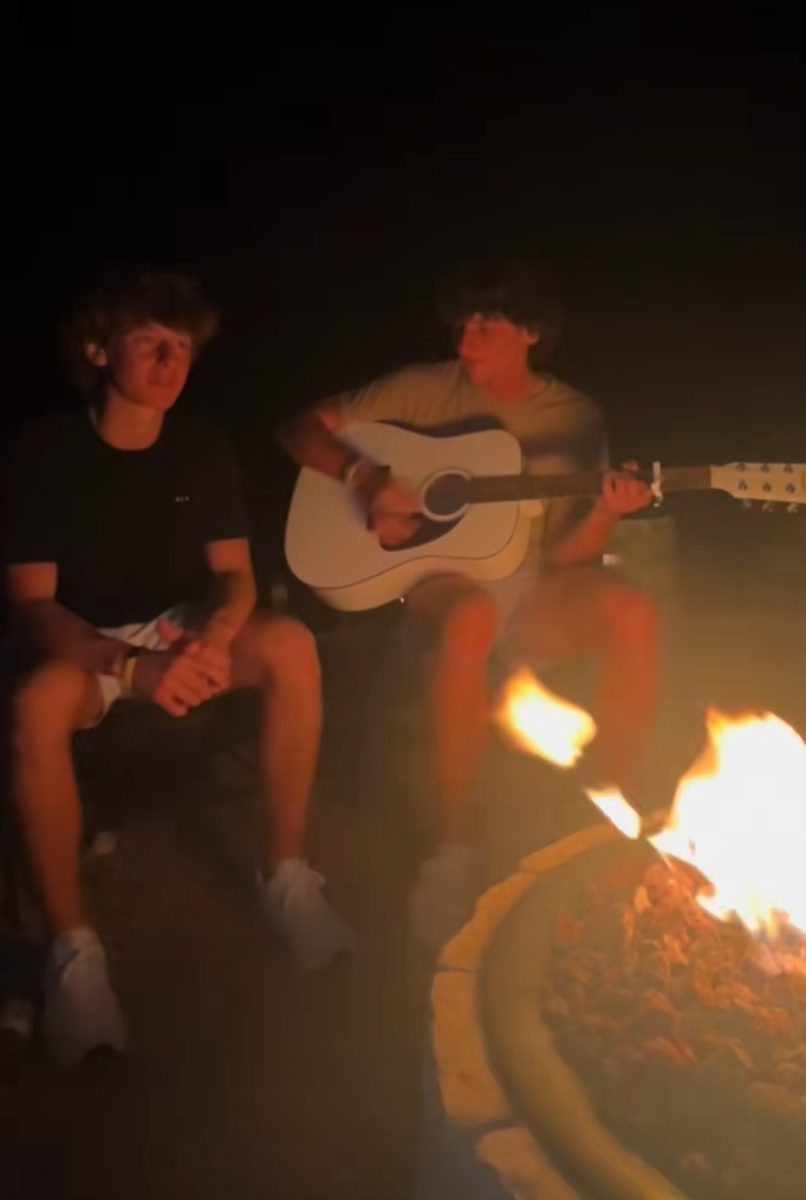 Michael and Bryson sing and play guitar around their campfire. Their cover of the song "Evergreen" got 2.3 million views.