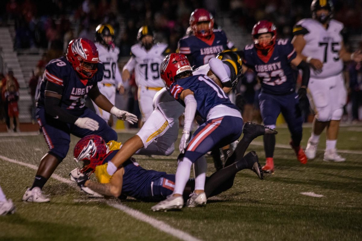 Riley Decaro (12) trips up a Francis Howell North ball carrier as #79 Kaleb Rhen (12) and #11 Caleb Clay assist. The Eagles defense allowed just a lone touchdown in the first quarter.  
