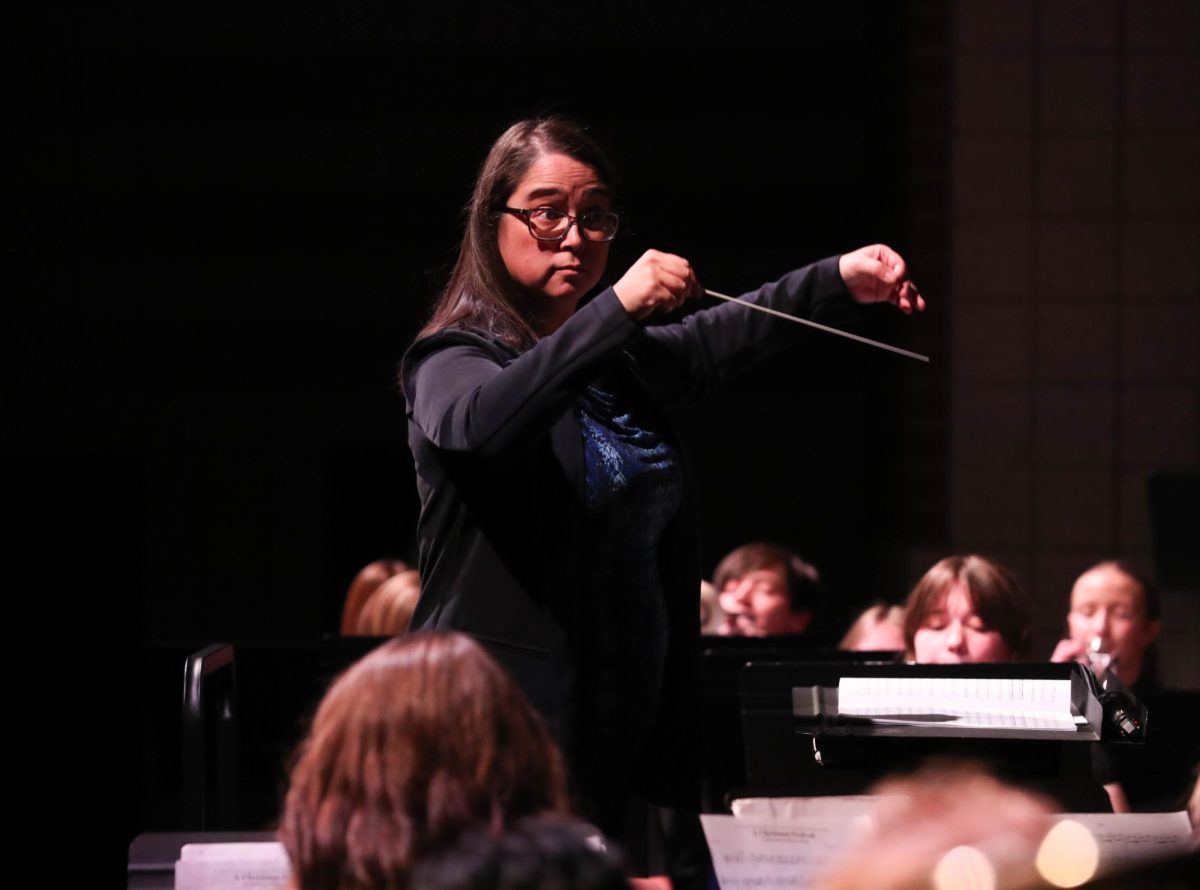 Sarita Magno-Parsons directs concert band during their last song, "A Christmas Festival" by Anderson, arr. Smith.