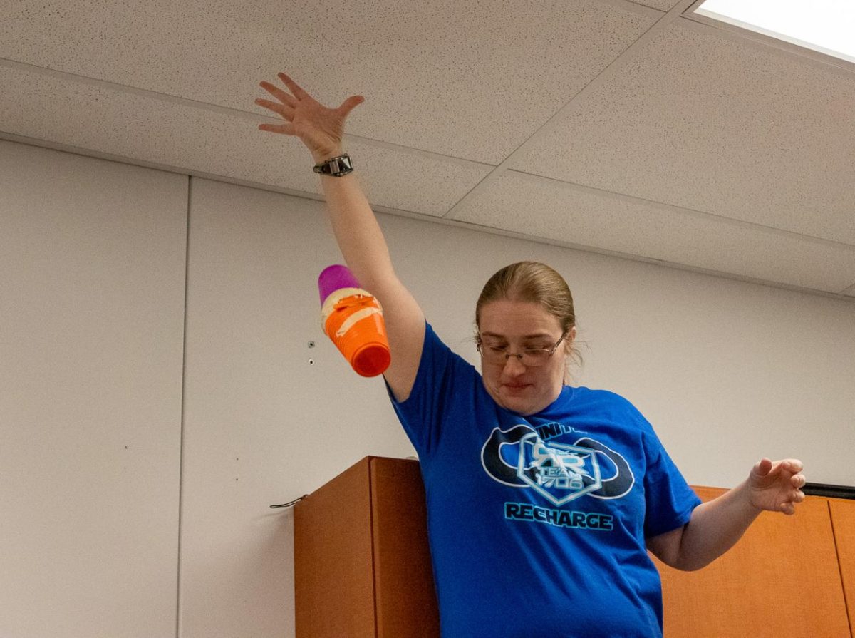 Ms. Deatherage drops an egg contraption from the ceiling to see if it will crack.