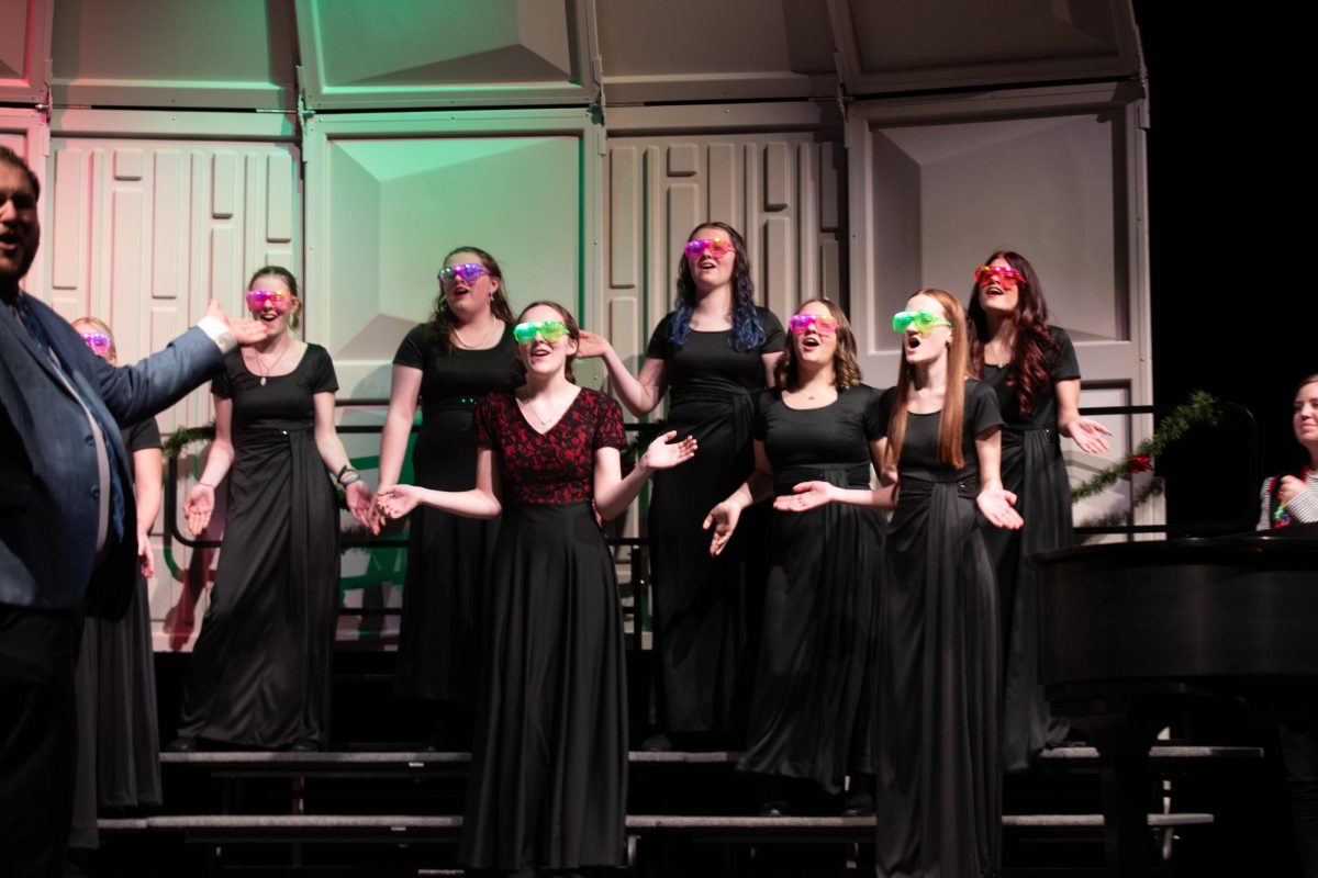 Select Treble Choir claps along while singing a song during the winter choir concert.