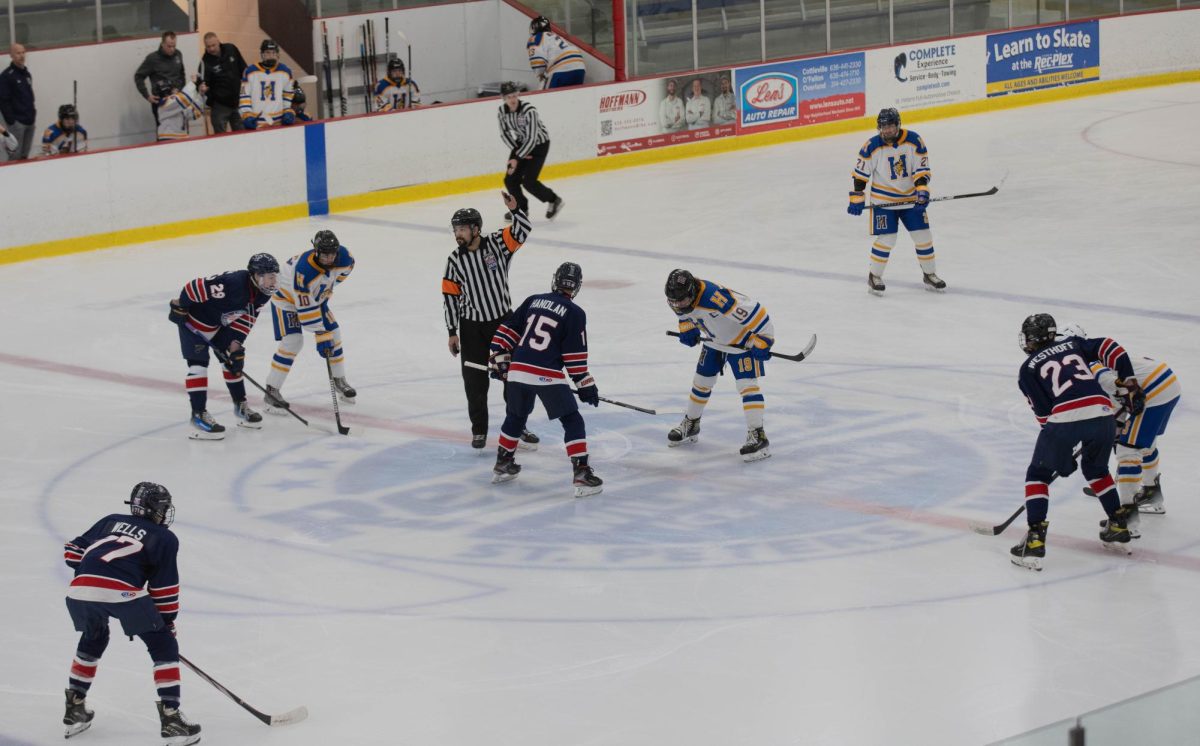 Dylan Handlan (12) takes the opening face of vs Francis Howell's Jonah Vaughn.