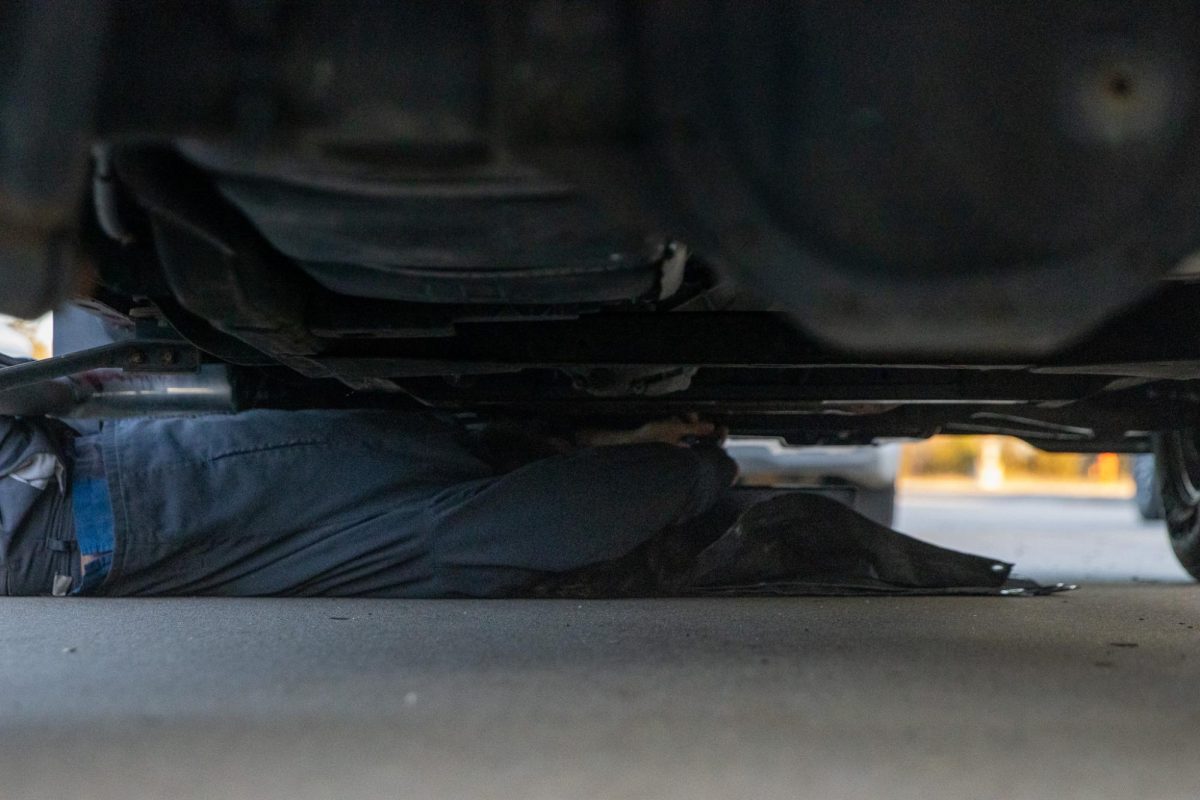 A Lou Fusz employee changes an oil filter in a staff member's truck.