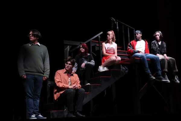 A scene from the ominous fall play "Trap" with Noah Block (12), Gabe Segovia (12), Clem Arrey (11), Brooklyn Donohue (10), Kalen Treadway (12), and Auggie Deters (9).