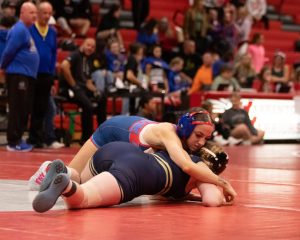 Ava Hall (10) pins down her opponent in the first tournament of the season.