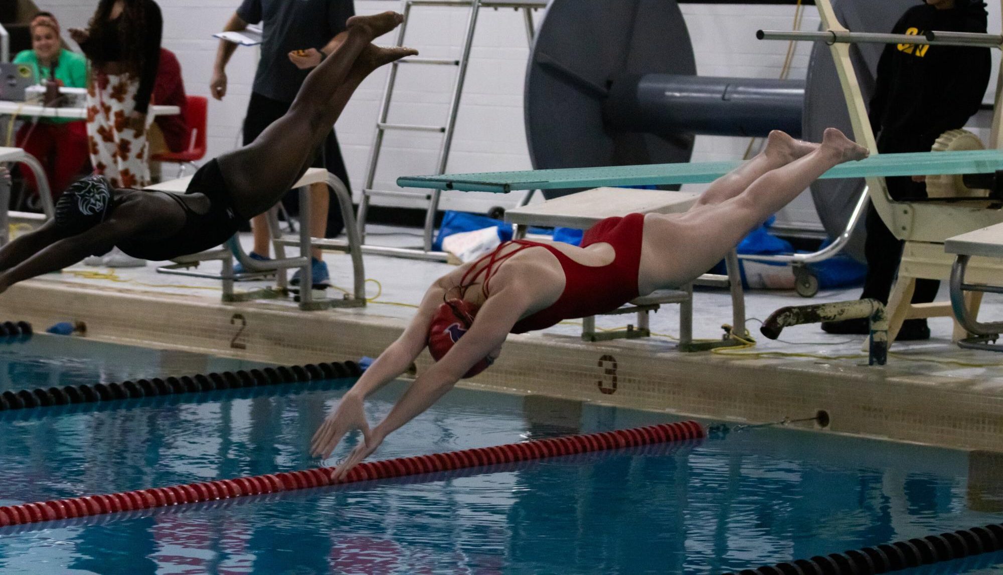 Emma Nolan (12) dives into the water from the block for her 50 free.