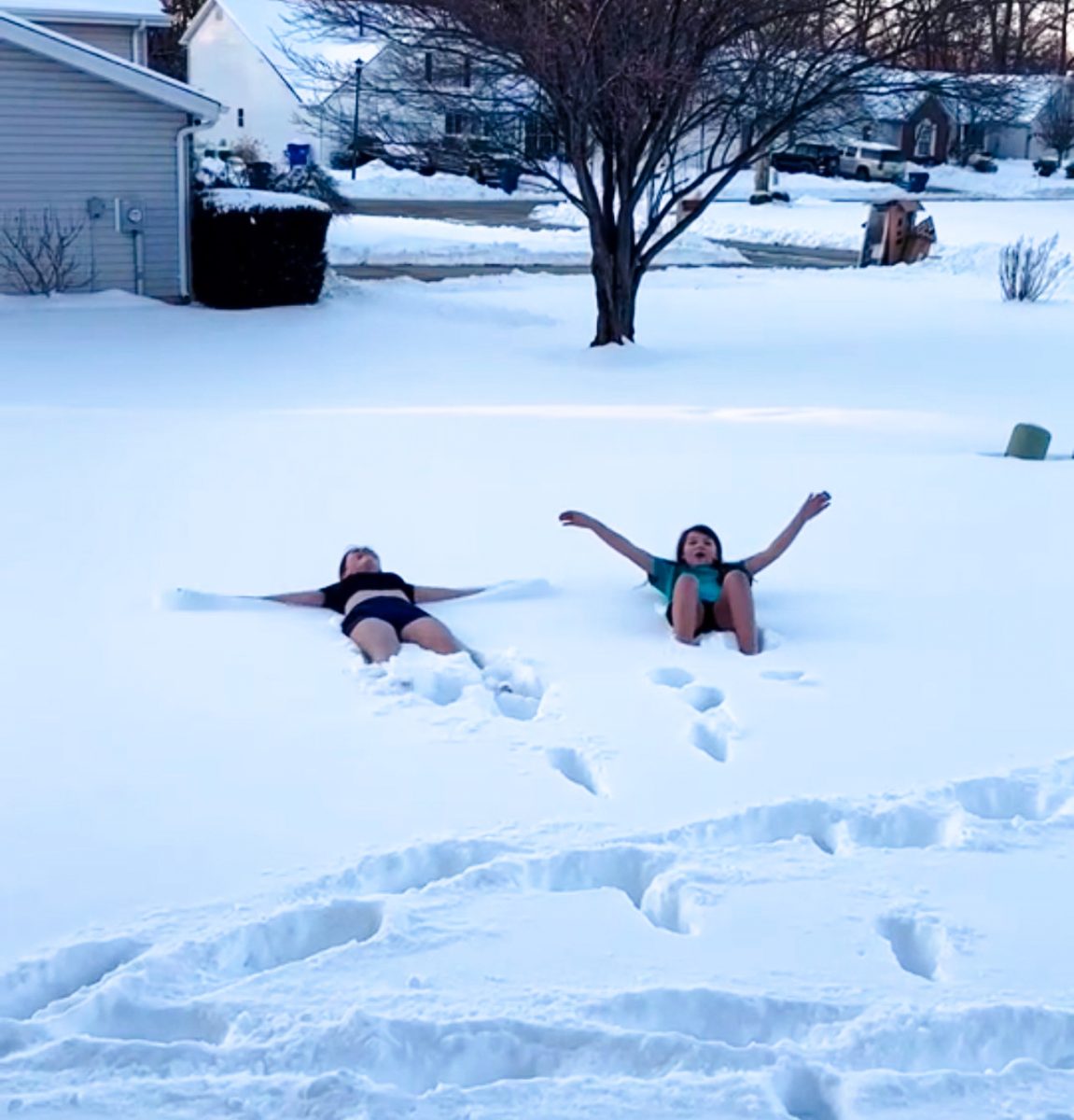 Bella Milatovic (9) and her sister roll around in the snow for the challenge.