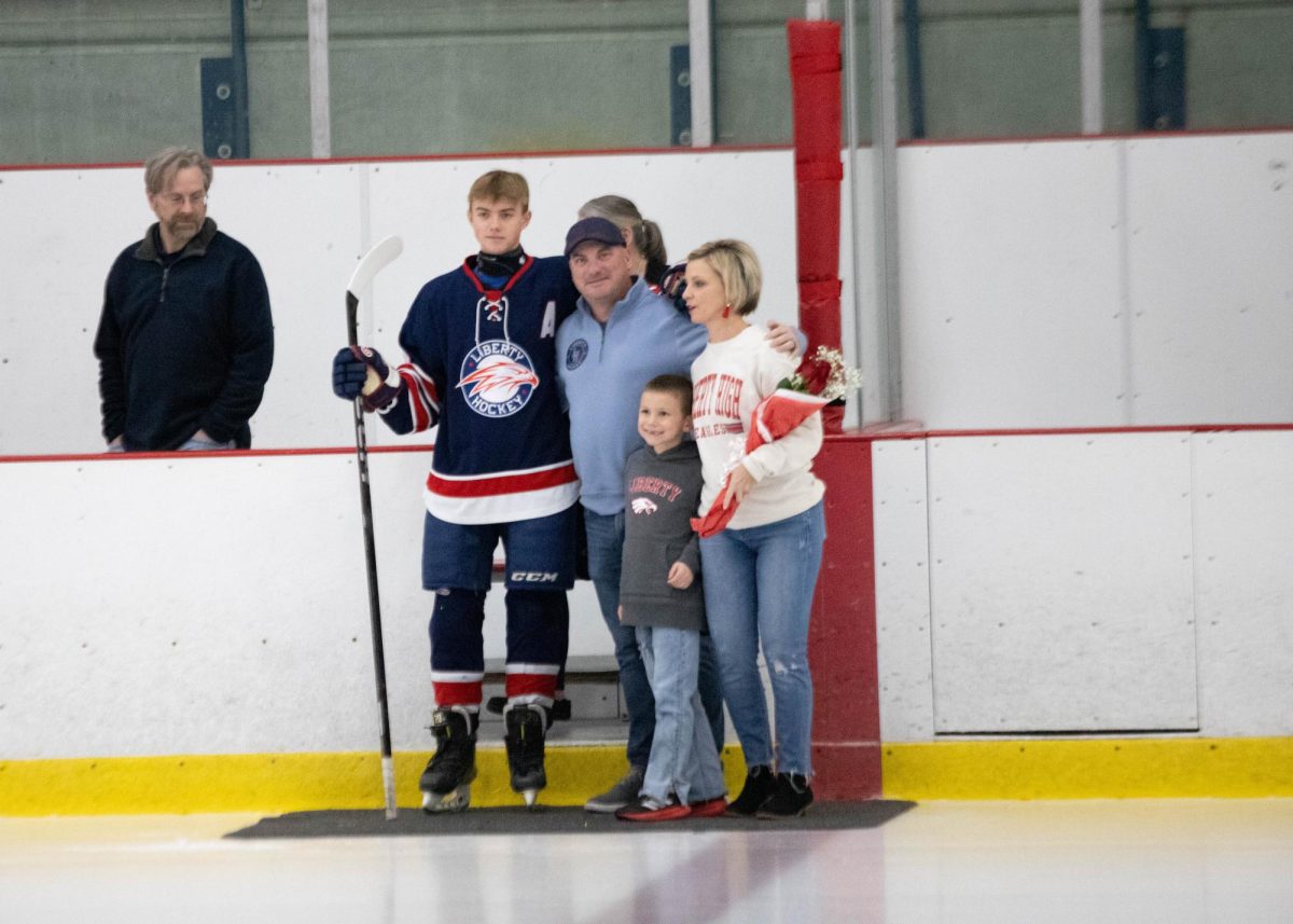 Dylan Handlan and family pose for picture during senior night ceremony.
