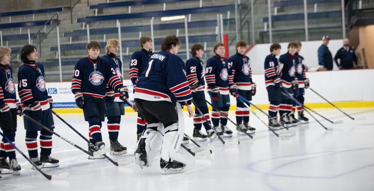 Ben Teismann (12) skates over to parents and coaches during the ceremony. 