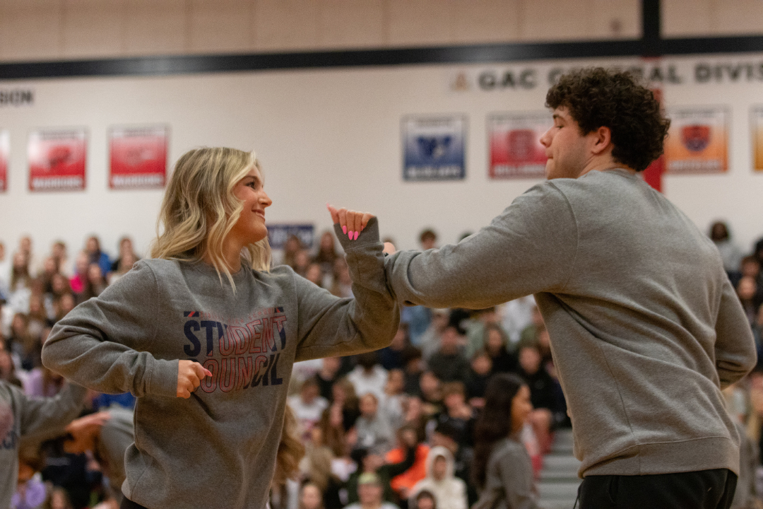 Jack Ryan (12) and Reagan Bone (12) hit arms as part of their dance.